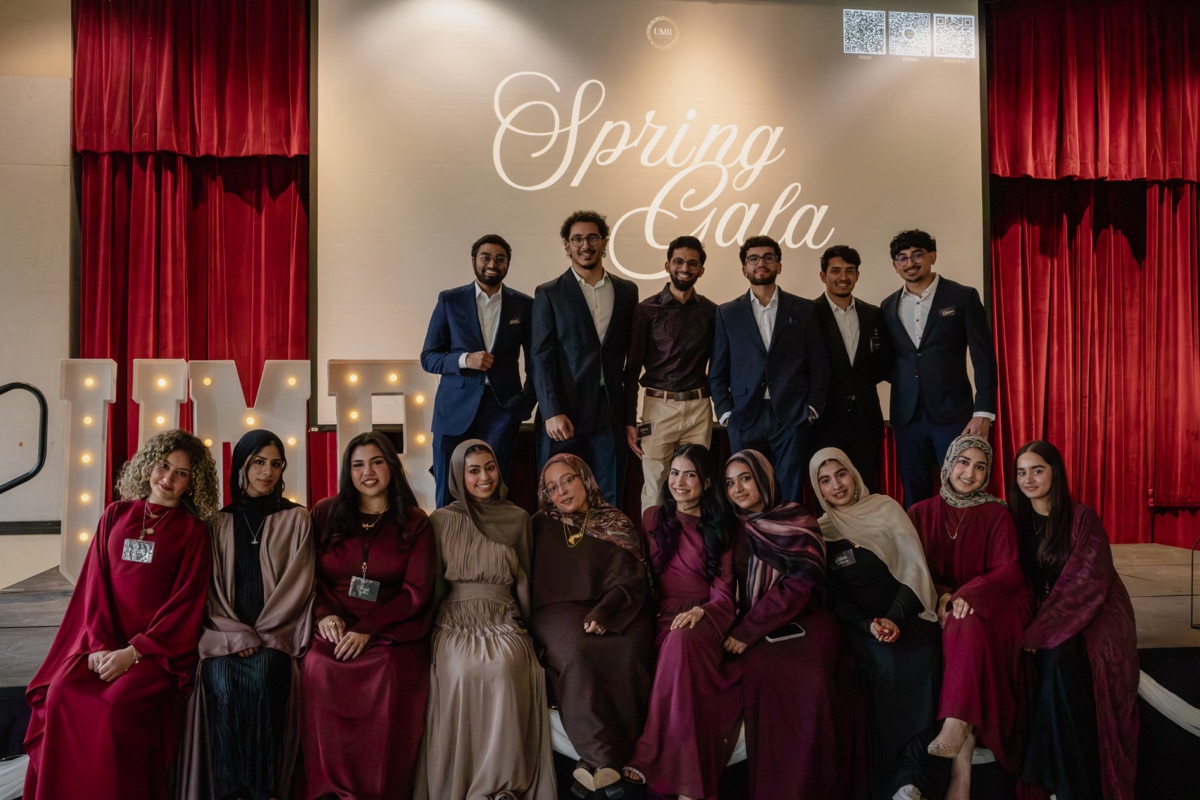 The UMR team posing in front of a lit UMR marquee sign at the Spring Gala.